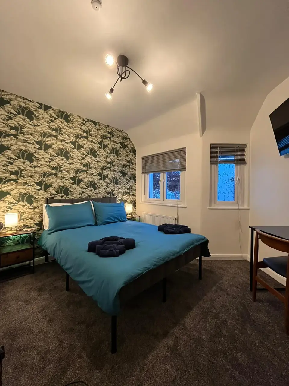 Spacious double en-suite room with botanical feature wall